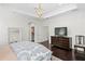 Main bedroom with trey ceilings, dresser and access to walk-in closet at 4310 W Sevilla St, Tampa, FL 33629