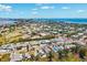 An aerial view of a vibrant coastal town featuring a mix of residential and commercial properties near the oceanfront at 438 62Nd St, Holmes Beach, FL 34217