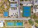 Aerial shot showcases tennis and basketball courts with parking in a residential community on a bright, sunny day at 438 62Nd St, Holmes Beach, FL 34217