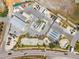 Aerial view of a commercial area with industrial buildings, a skate park, and ample parking along a busy street at 438 62Nd St, Holmes Beach, FL 34217