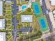 Aerial view showcases a community pool, tennis courts, lush landscaping and parking with residential properties at 438 62Nd St, Holmes Beach, FL 34217