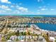 Aerial view showcases a coastal community with waterfront homes, canals, and ocean access on a clear, sunny day at 438 62Nd St, Holmes Beach, FL 34217