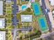 Aerial shot showcases community amenities: a pool, jacuzzi, and tennis courts surrounded by lush landscaping and parking at 438 62Nd St, Holmes Beach, FL 34217