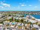An aerial view of a coastal community with waterfront homes and access to the ocean under a bright, sunny sky at 438 62Nd St, Holmes Beach, FL 34217