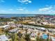 City aerial view displaying waterfront community, residential areas, and nearby amenities with lush greenery at 438 62Nd St, Holmes Beach, FL 34217