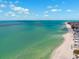 Expansive aerial perspective of a serene shoreline meeting tranquil turquoise waters at 438 62Nd St, Holmes Beach, FL 34217