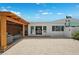 Backyard featuring a covered patio, deck and a gravel area with exterior access through sliding glass doors at 438 62Nd St, Holmes Beach, FL 34217