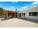 Backyard featuring a covered patio, deck and a gravel area and exterior access through sliding glass doors at 438 62Nd St, Holmes Beach, FL 34217