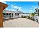 Backyard featuring a covered patio, deck and a gravel area leading to a fence and vegetation at 438 62Nd St, Holmes Beach, FL 34217