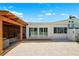 Backyard featuring a covered patio, deck and a gravel area with exterior access through sliding glass doors at 438 62Nd St, Holmes Beach, FL 34217