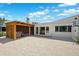 Backyard featuring a covered patio, deck and a gravel area and exterior access through sliding glass doors at 438 62Nd St, Holmes Beach, FL 34217