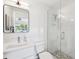 Modern bathroom featuring a glass shower, tiled floors and a large mirror at 438 62Nd St, Holmes Beach, FL 34217