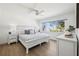 Cozy bedroom with light colored walls, light wood floors, and a window to the exterior at 438 62Nd St, Holmes Beach, FL 34217