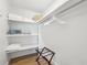 Walk-in closet with built-in shelves and wooden floors at 438 62Nd St, Holmes Beach, FL 34217