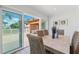 Dining area with view of the exterior pergola and patio space through sliding glass doors at 438 62Nd St, Holmes Beach, FL 34217