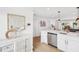 Bright kitchen boasts stainless steel appliances, white cabinets, and modern finishes with adjoining living room at 438 62Nd St, Holmes Beach, FL 34217