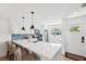 Bright kitchen features a quartz countertop, stainless steel appliances, and modern pendant lighting at 438 62Nd St, Holmes Beach, FL 34217