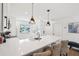 Kitchen featuring modern pendant lighting, a breakfast bar with seating, and stainless steel appliances at 438 62Nd St, Holmes Beach, FL 34217