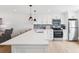 Spacious kitchen with stainless steel appliances, quartz counters, a breakfast bar, and a blue backsplash at 438 62Nd St, Holmes Beach, FL 34217
