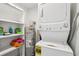 Laundry room area features a stackable washer/dryer, shelves, and a water heater at 438 62Nd St, Holmes Beach, FL 34217