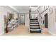 Grand foyer featuring modern decor, a staircase with metal railings, and tile flooring at 440 S Gulfview Blvd # 1701, Clearwater Beach, FL 33767