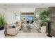 Bright living room with stone accent wall, plush sofas, and a view of the ocean at 440 S Gulfview Blvd # 1701, Clearwater Beach, FL 33767