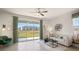 Bright living room featuring a ceiling fan, neutral walls, and a sliding glass door that offers backyard views at 526 Mangrove Shade Cir, Apollo Beach, FL 33572