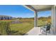 Covered patio with seating overlooking a well-manicured lawn and pond with fountain feature at 526 Mangrove Shade Cir, Apollo Beach, FL 33572