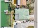 Top-down aerial view of home showcasing the roof, landscaping, and waterfront location with dock at 540 115Th Ave, Treasure Island, FL 33706