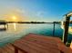 Waterfront dock featuring a seating area and beautiful views of the surrounding water and sunset at 540 115Th Ave, Treasure Island, FL 33706