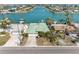 Aerial view of a home with a green roof, surrounded by palm trees and waterfront access at 540 115Th Ave, Treasure Island, FL 33706