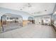Spacious room with tile floors, windows, and open archways ready for renovation at 540 115Th Ave, Treasure Island, FL 33706