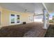 Large, covered patio with brick flooring, ceiling fans and views of the waterfront at 540 115Th Ave, Treasure Island, FL 33706