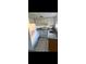 Functional kitchen includes white cabinetry, granite countertops, and essential appliances, offering practical design at 5715 Townhouse Dr # 1, New Port Richey, FL 34652