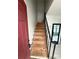 Staircase leading to the upper level, offering an opportunity for renovation and personalization at 5715 Townhouse Dr # 1, New Port Richey, FL 34652