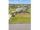 Aerial view of a well-maintained home with a lush lawn and access to a serene waterfront at 6181 9Th Avenue Ne Cir, Bradenton, FL 34212