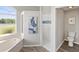 This bathroom features a large soaking tub and tiled walk-in shower with custom tile at 6181 9Th Avenue Ne Cir, Bradenton, FL 34212