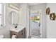 This bathroom features a single sink vanity with outside access to a pool at 6181 9Th Avenue Ne Cir, Bradenton, FL 34212