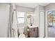 This bathroom features a single sink vanity, tiled shower, and outdoor access to a pool at 6181 9Th Avenue Ne Cir, Bradenton, FL 34212