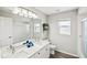This bathroom features a double sink vanity, walk-in shower, and lots of natural light at 6181 9Th Avenue Ne Cir, Bradenton, FL 34212