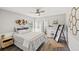 Bedroom with wood floors, a cozy bed, modern decor, and a view of the water at 6181 9Th Avenue Ne Cir, Bradenton, FL 34212