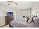 This spacious bedroom features a ceiling fan, dresser, and private outdoor access at 6181 9Th Avenue Ne Cir, Bradenton, FL 34212