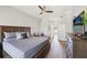 This primary bedroom features a ceiling fan, wood-look floors, and a private ensuite at 6181 9Th Avenue Ne Cir, Bradenton, FL 34212