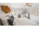 Well-decorated bedroom with stylish decor, wood floors, and a view into an en-suite bathroom at 6181 9Th Avenue Ne Cir, Bradenton, FL 34212