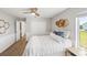 This cozy bedroom features wood floors, decorative wall accents, and a ceiling fan at 6181 9Th Avenue Ne Cir, Bradenton, FL 34212
