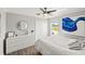 This bedroom features a ceiling fan, dresser, and closet for plenty of storage space at 6181 9Th Avenue Ne Cir, Bradenton, FL 34212