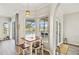 Bright breakfast nook with views of the pool area through large windows and a sliding glass door at 6181 9Th Avenue Ne Cir, Bradenton, FL 34212