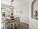 Bright dining area with elegant light fixture, a large window, and light gray walls with white trim at 6181 9Th Avenue Ne Cir, Bradenton, FL 34212