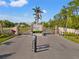 Cypress Creek Estates entrance gate features an American flag and well-maintained landscaping at 6181 9Th Avenue Ne Cir, Bradenton, FL 34212