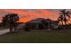 Inviting home featuring a manicured lawn, tile roof and enhanced by a gorgeous sunset at 6181 9Th Avenue Ne Cir, Bradenton, FL 34212